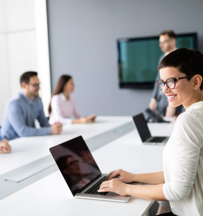 Group of lawyers discussing contract together in office Group of lawyers in suits discussing contract together in office