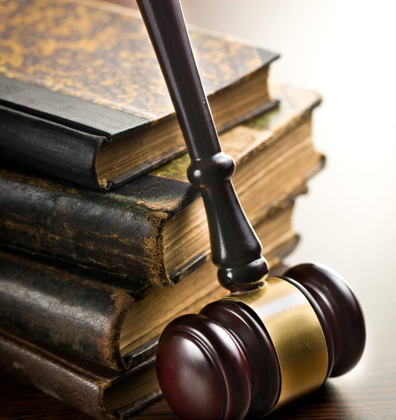 judge gavel with old books on wooden background